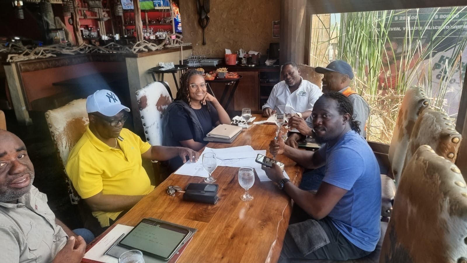 The Karibu Condominiums project team reviewing documents together around a table